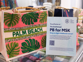 A sign with information about PB for MSK next to a colorful tote bag with "Palm Beach."