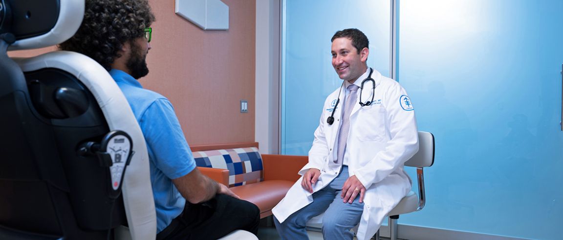 An MSK doctor with a patient in an exam room
