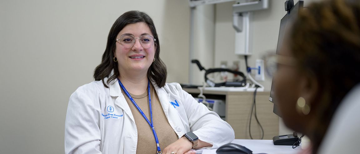 An MSK nurse speaks with a patient in an exam room.
