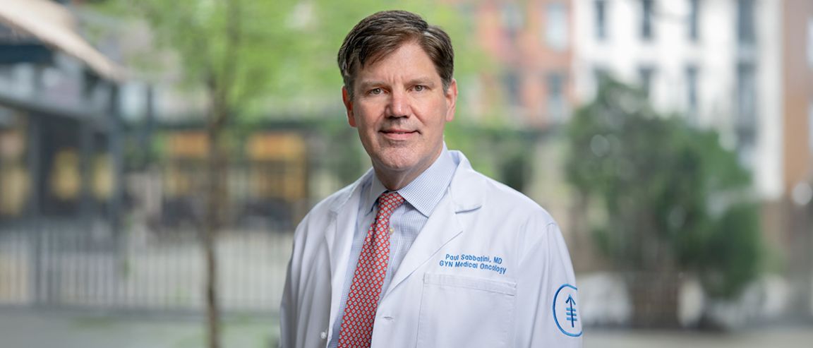 Dr. Paul Sabbatini, Senior Vice President for Clinical Research at MSK, wearing a white lab coat outdoors.