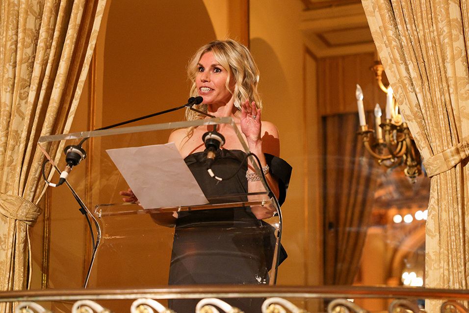 Austen Cruz stands at a podium addressing the crowd at the Fall Party. 