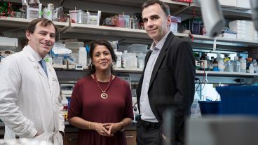 Three MSK experts stand in a lab.